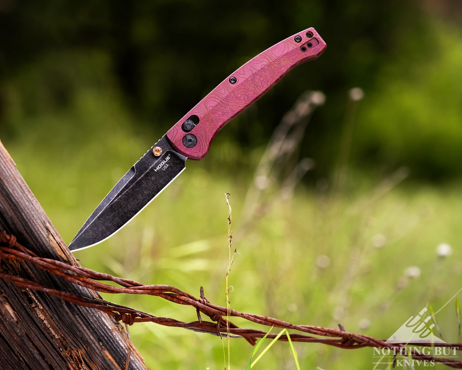 Hogue Mysto Review - Image 5 The Hogue Mysto sticking out of a fence post in a green pasture on a ranch.